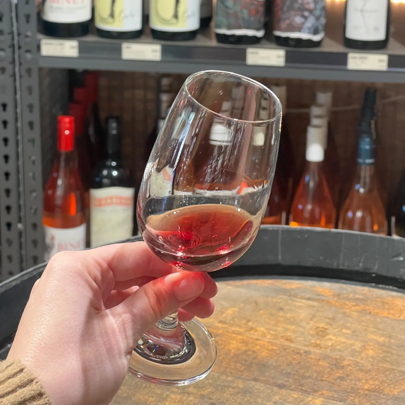 red wine in a glass in someone's hand